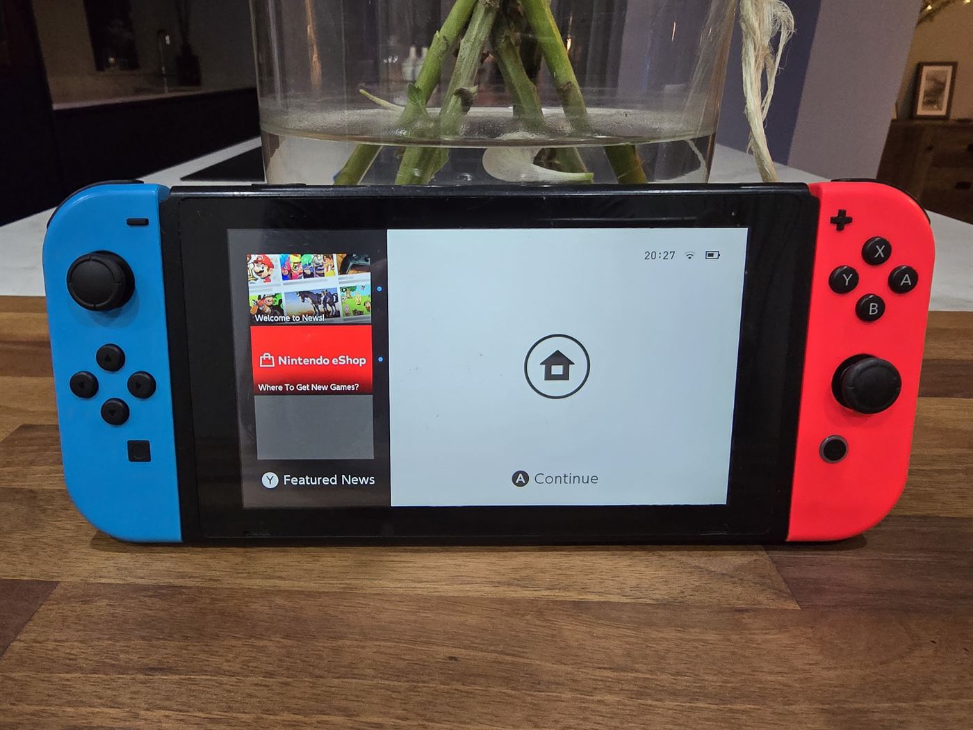 Nintendo Switch console with neon red and blue Joy-Cons, home screen