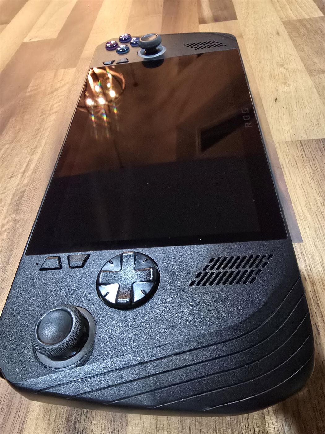 ASUS ROG Ally X handheld, close-up of corner showing minor cosmetic crack
